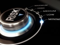 Switch button positioned on the word minimum, black background and blue light. Conceptual image for illustration of Risk management or assessment.